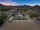 Aerial view showcases expansive lot with unique house design and a long carport at 647 Foxhall Rd, Henderson, NV 89002