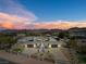Stunning aerial view of home showing unique design, desert landscape and mountain views at 647 Foxhall Rd, Henderson, NV 89002