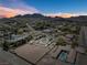 Aerial view displays property's layout in a desert setting with mountain views and neighborhood at 647 Foxhall Rd, Henderson, NV 89002