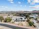 Stunning aerial view of the property with desert landscape and mountain views at 647 Foxhall Rd, Henderson, NV 89002