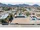 Wide aerial shot of a property with a unique courtyard pool design and ample land at 647 Foxhall Rd, Henderson, NV 89002