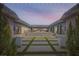 Beautiful backyard design featuring a unique lawn with seating and a covered patio beyond at 647 Foxhall Rd, Henderson, NV 89002