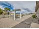 View of a backyard with desert landscaping and a covered patio area with a fire pit at 647 Foxhall Rd, Henderson, NV 89002