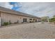 Spacious backyard with desert landscaping, minimal plantings, and a covered outdoor seating area at 647 Foxhall Rd, Henderson, NV 89002