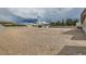Vast backyard showing minimal landscaping, a surrounding fence, and desert terrain at 647 Foxhall Rd, Henderson, NV 89002