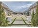 Beautiful backyard design featuring a unique lawn with seating and a covered patio beyond at 647 Foxhall Rd, Henderson, NV 89002