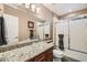 Stylish bathroom featuring a glass bowl sink, granite countertops, and a decorative shower door at 647 Foxhall Rd, Henderson, NV 89002