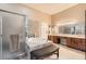 Bathroom featuring a jacuzzi tub with decorative tile surround and a large vanity with double sinks at 647 Foxhall Rd, Henderson, NV 89002