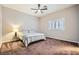 Serene bedroom featuring a neutral color palette, plush carpeting, and a ceiling fan for added comfort at 647 Foxhall Rd, Henderson, NV 89002