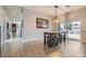 Dining area featuring modern chandelier, a dining table with stools, and lots of natural light at 647 Foxhall Rd, Henderson, NV 89002