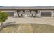 Home featuring dual garage, desert landscaping, and circular driveway at 647 Foxhall Rd, Henderson, NV 89002