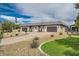Beautiful home showcasing desert landscaping, dual garages, and a welcoming circular driveway at 647 Foxhall Rd, Henderson, NV 89002