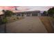Home featuring a circular driveway, desert landscaping and American flag in the front yard at 647 Foxhall Rd, Henderson, NV 89002