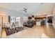 Spacious living room featuring tile floors, ceiling fan, and bar seating with a view into the kitchen at 647 Foxhall Rd, Henderson, NV 89002