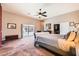 Spacious bedroom featuring a ceiling fan, sliding glass doors, and a walk-in closet for ample storage at 647 Foxhall Rd, Henderson, NV 89002
