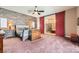 Main bedroom with plank wall, red sliding barn doors to ensuite bathroom at 647 Foxhall Rd, Henderson, NV 89002