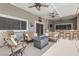 Inviting outdoor living space with comfortable seating, a ceiling fan, and a built-in bar area at 647 Foxhall Rd, Henderson, NV 89002
