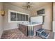 Relaxing outdoor spa on a covered patio, complete with a ceiling fan and adjacent seating area at 647 Foxhall Rd, Henderson, NV 89002