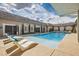 Resort-style pool with lounge chairs, and lush landscaping, creating a relaxing oasis at 647 Foxhall Rd, Henderson, NV 89002