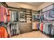 Organized walk-in closet with built-in shelving, drawers, and hanging rods for maximum storage capacity at 647 Foxhall Rd, Henderson, NV 89002