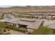 Expansive aerial view of a single-story home in a well-planned community, with desert landscaping and mountain views at 6700 Regency Stone Way, Las Vegas, NV 89148