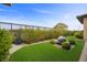 Beautiful backyard features a modern water feature, green space and privacy landscaping at 6700 Regency Stone Way, Las Vegas, NV 89148