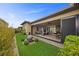 Inviting backyard patio with open sliding glass doors and ample seating for outdoor entertainment at 6700 Regency Stone Way, Las Vegas, NV 89148
