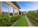 Lush backyard with an artificial grass pathway complements the water feature at 6700 Regency Stone Way, Las Vegas, NV 89148