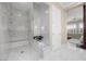 Bathroom with white marble walk-in shower and separate commode at 6700 Regency Stone Way, Las Vegas, NV 89148