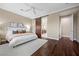 Bedroom features hardwood floors, ceiling fan, neutral paint and barn door at 6700 Regency Stone Way, Las Vegas, NV 89148