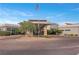 Grand entrance to the community clubhouse with circular driveway and well-manicured landscaping at 6700 Regency Stone Way, Las Vegas, NV 89148