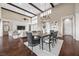 Elegant dining area showcasing a modern chandelier and bright living room views at 6700 Regency Stone Way, Las Vegas, NV 89148