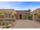 Stunning home featuring a modern elevation, a stone facade, with desert landscaping at 6700 Regency Stone Way, Las Vegas, NV 89148