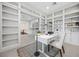Well-lit home office with white bookshelves and a desk, adjacent to the kitchen at 6700 Regency Stone Way, Las Vegas, NV 89148
