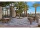 Beautiful outdoor patio area with ample seating and views of the surrounding greenery and palm trees at 6700 Regency Stone Way, Las Vegas, NV 89148