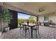 Covered patio with stylish dining and seating offers an inviting outdoor space at 6700 Regency Stone Way, Las Vegas, NV 89148