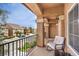 A cozy balcony with an outside view, comfortable chair, and metal railing, perfect for enjoying neighborhood views at 6843 Philharmonic Ave, Las Vegas, NV 89139