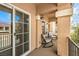This balcony features comfortable seating, views of the neighborhood, and a sliding glass door for seamless indoor-outdoor living at 6843 Philharmonic Ave, Las Vegas, NV 89139