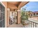 A balcony offering seating, wrought iron railings, and views of the neighborhood; an ideal spot for relaxation and enjoying the scenery at 6843 Philharmonic Ave, Las Vegas, NV 89139