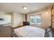 Well-lit bedroom with hardwood floors, dark dresser and a view of the outside at 6843 Philharmonic Ave, Las Vegas, NV 89139