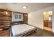 Bright bedroom with hardwood floors, wood accent wall and a view to the bathroom at 6843 Philharmonic Ave, Las Vegas, NV 89139