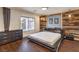 Modern bedroom with hardwood floors, wood accent wall, and plenty of natural light at 6843 Philharmonic Ave, Las Vegas, NV 89139