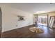 Bright bonus room with sliding glass door, floating shelves, dark wood floors and exercise equipment at 6843 Philharmonic Ave, Las Vegas, NV 89139