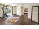 Spacious bonus room with dark wood floors, access to the backyard and view of bedroom at 6843 Philharmonic Ave, Las Vegas, NV 89139