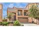 Charming two-story home boasts a front-facing balcony, tile roof, and a two-car garage in a landscaped community at 6843 Philharmonic Ave, Las Vegas, NV 89139