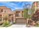 Inviting two-story home with a balcony, a 2-car garage, desert landscaping, and energy-efficient solar panels at 6843 Philharmonic Ave, Las Vegas, NV 89139
