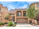 Two-story home featuring a tile roof, balcony, two car garage and meticulously manicured lawn at 6843 Philharmonic Ave, Las Vegas, NV 89139
