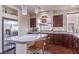 Stylish kitchen featuring granite countertops, stainless steel appliances, and a central island with seating at 6843 Philharmonic Ave, Las Vegas, NV 89139