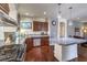 Modern kitchen with granite countertops, stainless steel appliances, and dark wood cabinets at 6843 Philharmonic Ave, Las Vegas, NV 89139