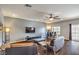 Cozy living room featuring dark wood floors, contemporary furniture, and a large flat-screen TV at 6843 Philharmonic Ave, Las Vegas, NV 89139